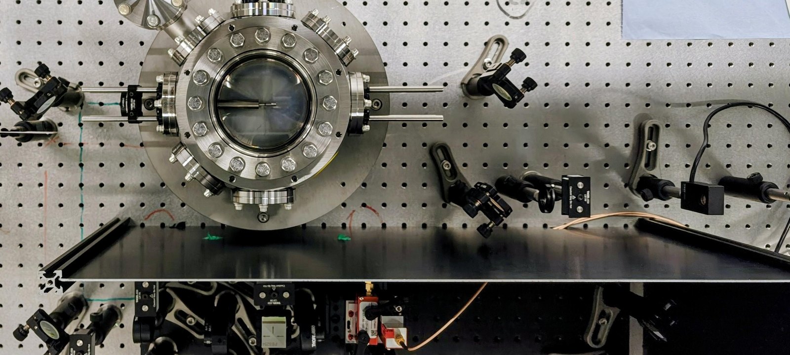 Optomechanical levitating-sensor vacuum chamber and optics table